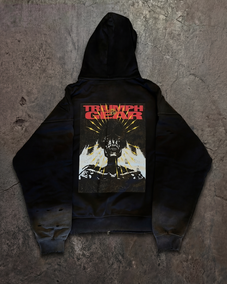 Black hoodie with graphic design on a textured gray surface