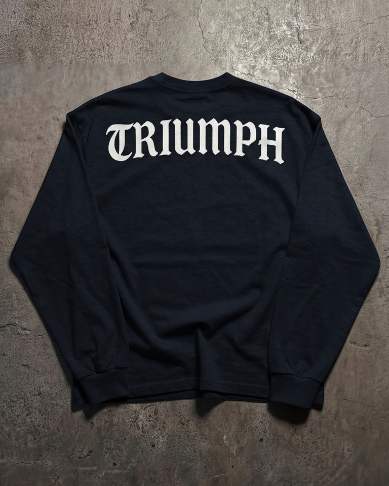 Navy long sleeve shirt with 'TRIUMPH' printed on the back against a textured gray background